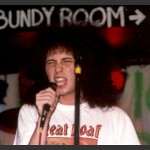 Ned Nugent, eyes shut, mouth open, committing to the song